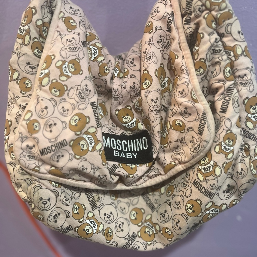 Moschino Baby bag . Used . Wear and tear inside for washing the bag .